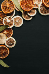 Fototapeta na wymiar Frame of dry fruits slices on black background