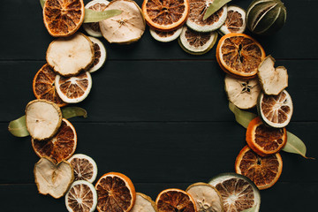 Frame of dry fruits slices on black background