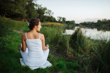 a young yogin girl sits in a meditative position