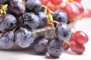 Blue, red and white grapes on the table. View with copy space