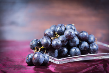 Blue grapes on the table. View with copy space