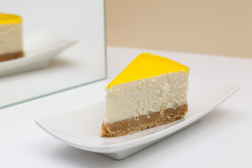 Fototapeta na wymiar One piece of lemon cheesecake on a white plate.