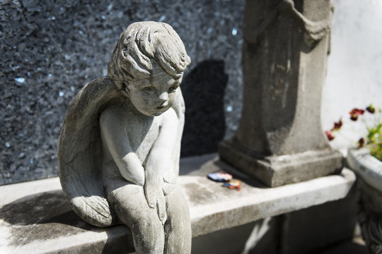 Detail of a tomb with a sad angel at the Lafayette Cemetery No. 1 in the city of New Orleans, Louisiana, USA