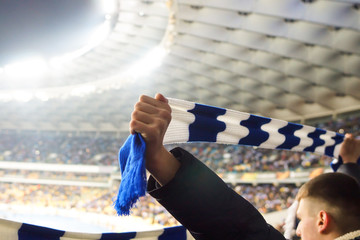 Football fans keep scarves with the color of their clubs