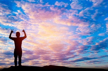 Fototapeta premium Silhouetted photo.He is standing are enjoying watching the evening glow. He is happy in good time. Photo concept for Silhouetted and good feel.