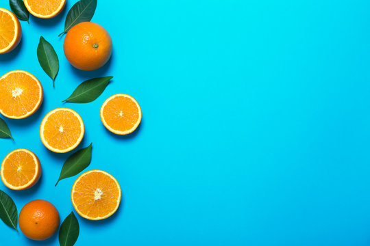 Fresh oranges on the blue background