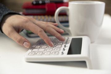 Woman hands working on calculator. Finances, economy, budgetand concept