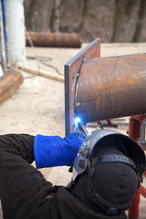 Worker welding in a factory. Welding on an industrial plant.