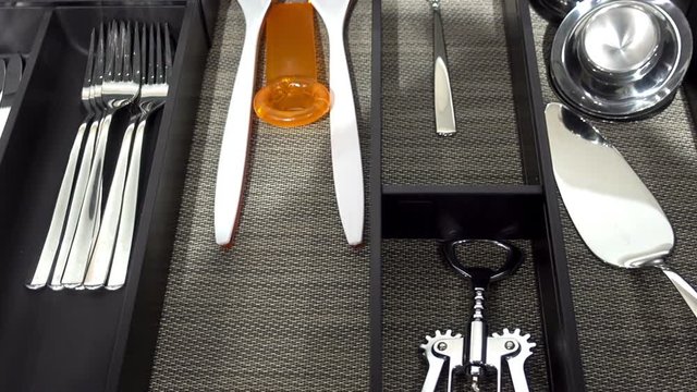 Spoons, forks and other cutlery in a modern cutlery box drawer. HD video     