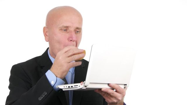 Hungry Businessman in Lunch Break Eat Sandwich and Work with a Laptop