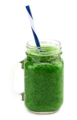 Healthy green smoothie with spinach in a jar mug isolated on white