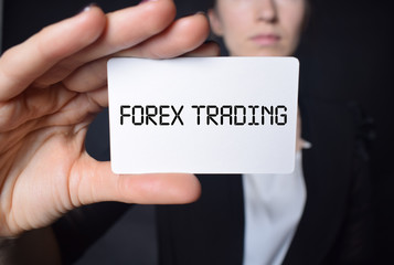Businessman shows business card with the inscription:FOREX TRADING