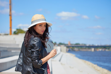 Portrait of happy smiling woman standing on the square on sunny summer or spring day outside, cute smiling woman looking at you,