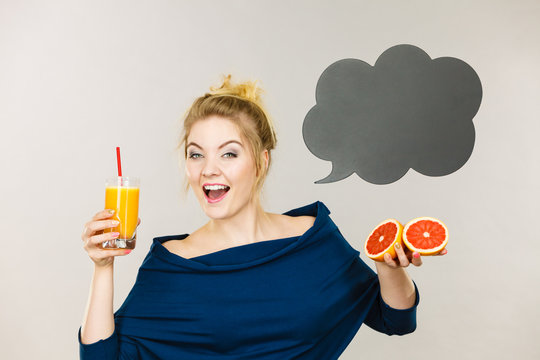 Happy woman holding fresh orange juice