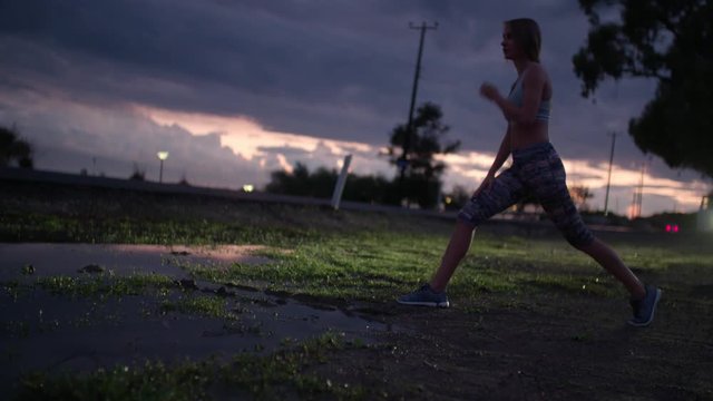 Runner stretching after intense exercise next to a road