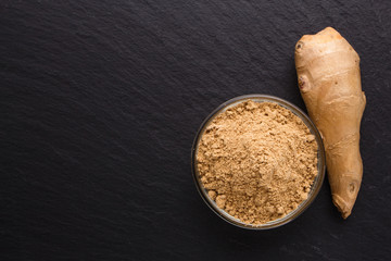 Ginger root on a dark stone background