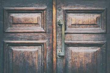 Vintage wooden door with a handle close up