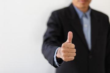 A businessman showing thumbs up on white background.