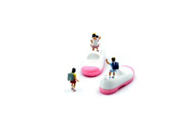 Miniature people : children with baby shoes.