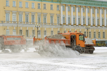 Snow-removal vehicles on the streets.