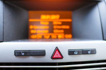 Fototapeta premium On-Board car computer to help the driver. Modern transport technologies in mechanical engineering. Close-up details of car interior. Accessories for vehicles, Buttons of alarm, heating, central lock