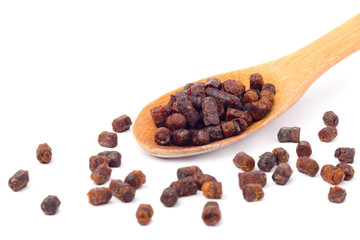 Granules of bee bread in a wooden spoon are isolated on a white background. Apitherapy. Beekeeping products. Strengthening immunity.