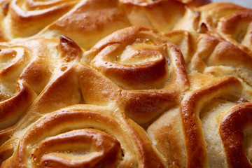 Homemade rose bread on white textured background, close-up, shallow depth of field, top view