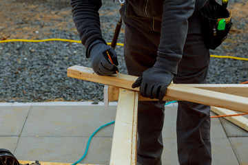 Closeup of a carpenter's hands builder at work with wooden construction