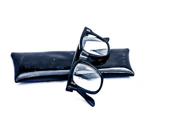Close up of black full rim frame reading spectacles isolated on a white.