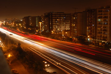Fototapeta na wymiar Street car lights at night on the road in perú