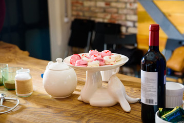 Pink and white macarons on white cakestand