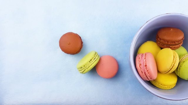 Macaroons or macaron on pastel blue surface. Close up.