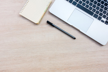 Office desk wood table with notebook and coffee cup, Top view with copy space.