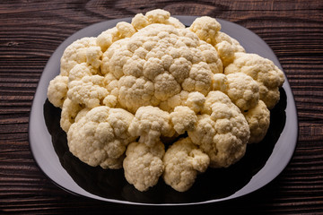 fresh cauliflower on a rustic wooden background