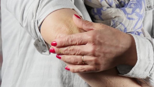 woman with elbow pain, close up