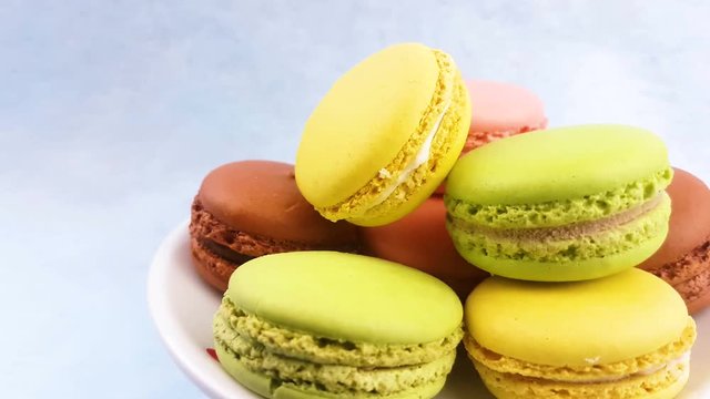 Macaroons or macaron on pastel blue surface. Close up.