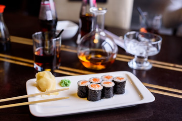 Fresh sushi rolls served on plate in restaurant