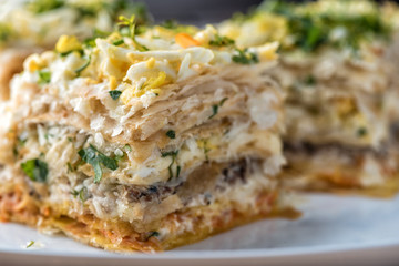 Fish pie with a dough, egg and fresh herbs, macro