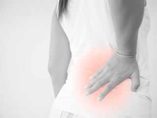 Close up woman having pain in injured back. Health care and back pain concept.