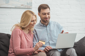 portrait of smiling family buying goods online together