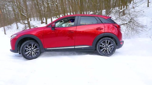 Red car drifts on snow