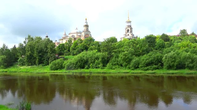 Cloudy July day on the Tvertsa river. View of the dome of the Borisoglebsky monastery. Torzhok, Tver region
