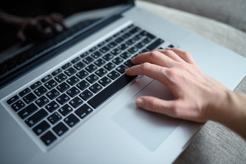 Black laptop keyboard. Close up of hand working on lap top, small depth of field