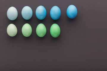 Easter background. Colored eggs on gray background