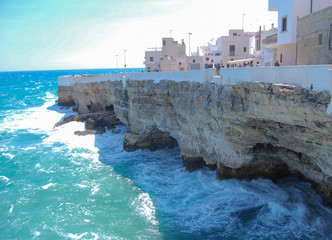 Coastal view of Polignano a Mare with rough sea and typical white houses - Italy