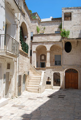 View of typical counrtyard among the white houses in Polignano a Mare - Puglia - Italy