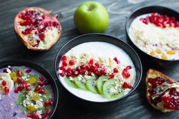 Delicious yoghurt smoothie bowls with assorted healthy fillings and fruit slices. Choosing the favorite taste for dieting