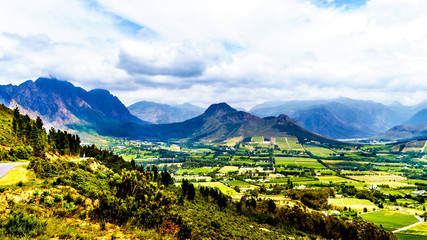 Fototapeta na wymiar Franschhoek Valley in the Western Cape province of South Africa with its many vineyards that are part of the Cape Winelands, surrounded by the Drakenstein mountain range, as seen from Franschhoek Pass