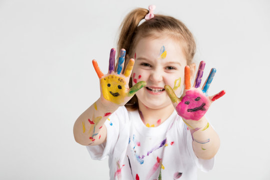 A girl showing her colorful painted hands