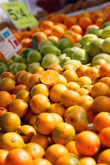 Mandarins on the counter in the market on a bright sunny day